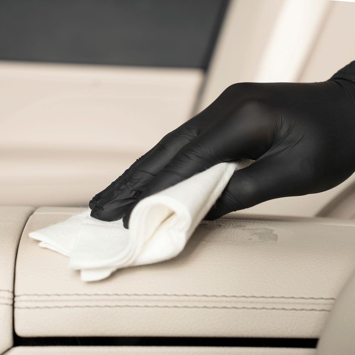 detiiling1.comLOURLOCK New Leather Care Set — wiping down a light leather armrest with a viscose cloth